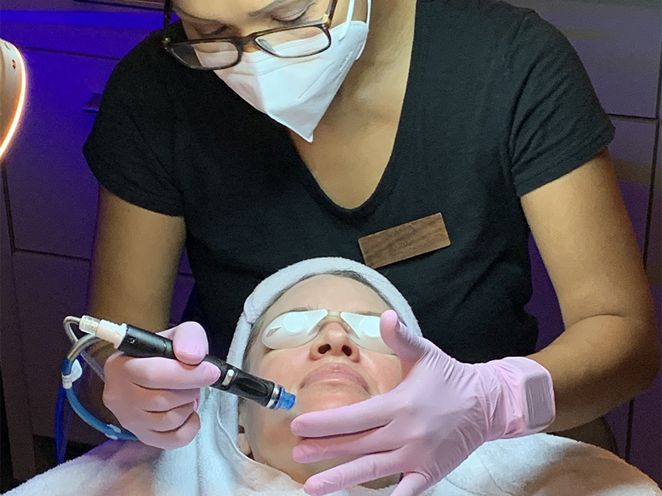 Viva Day Spa aesthetician providing a High-Touch Hydrafacial treatment to a skin care client at Viva Day Spa.